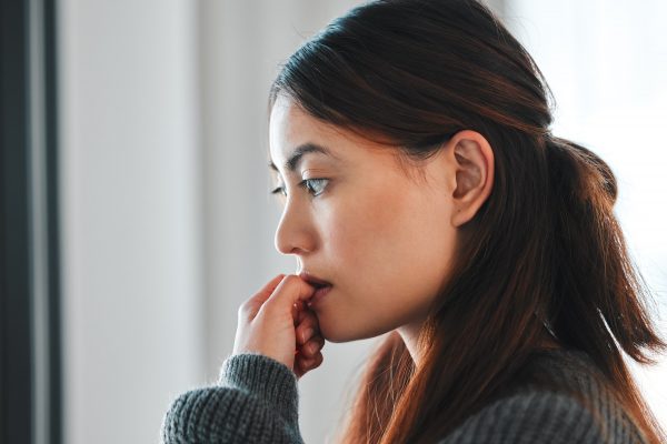 No control over my emotions. Shot of a young female experiencing paranoia at home.
