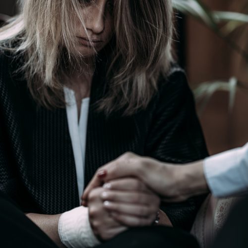 Psychotherapist Talking with Woman Suffering from PTSD.